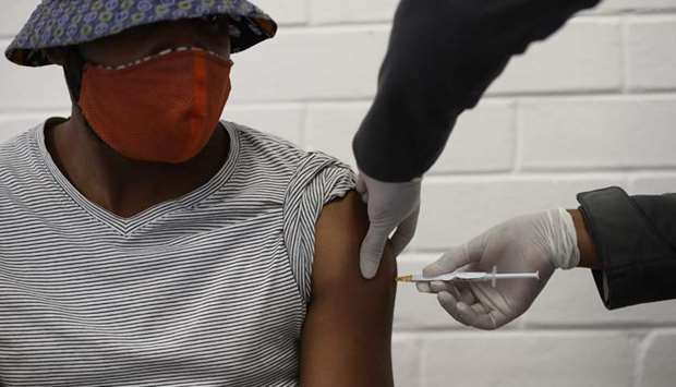 One of the first South African Oxford vaccine trialists looks on as a medical worker injects him with the clinical trial for a potential vaccine against the Covid-19 coronavirus at the Baragwanath hospital in Soweto, yesterday.