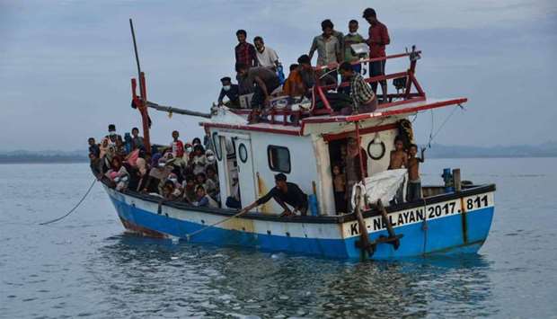 A boat carryingg Rohingya people from Myanmar arrives on the shorelines of Lancok village, in Indonesia's North Aceh Regency