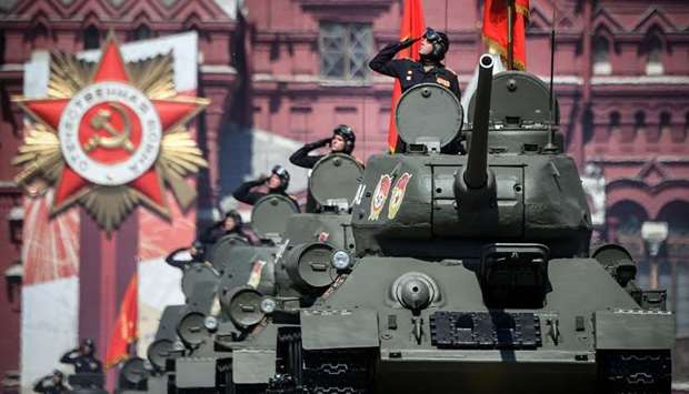 Soviet WWII-era T-34 tanks move through Red Square during a military parade in Moscow yesterday.