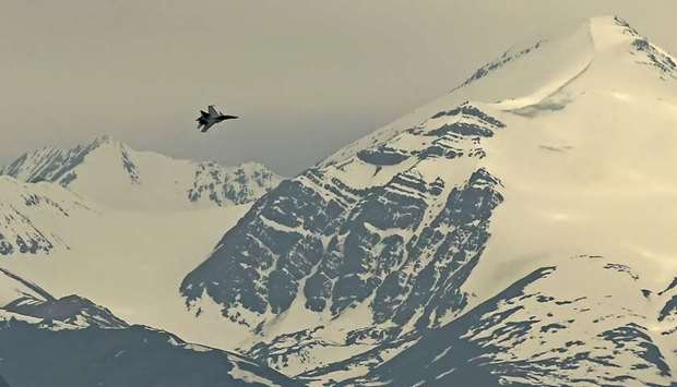 An Indian fighter jet flies over Leh, the capital of the union territory of Ladakh, yesterday. India is deploying more forces in a flashpoint region and trying to project military might.