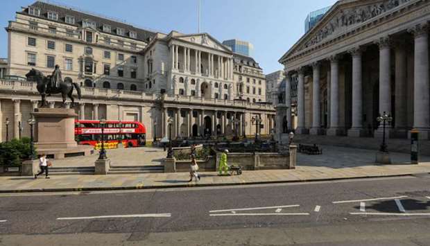 Pedestrians pass the Bank of England building in London. u201cThe BoE has instilled doubt about its commitment to QE in contrast to the Fed and ECB, to name only two,u201d Antoine Bouvet, a rates strategist at ING Groep NV. u201cThis means gilts volatility should be more elevated going forward, and we could also see some under-performance.u201d
