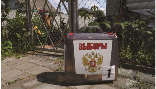 A mobile ballot box is seen as members of an electoral commission visit the houses of local residents during a seven-day vote on constitutional reforms, in the village of Ryazan, in the Moscow region. The writing on the ballot box reads u2018Electionu2019.