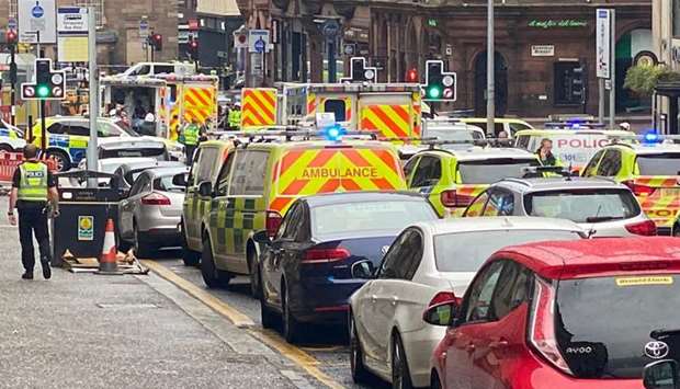 Emergency responders are seen near a scene of reported stabbings, in Glasgow, Scotland, in this picture obtained from social media