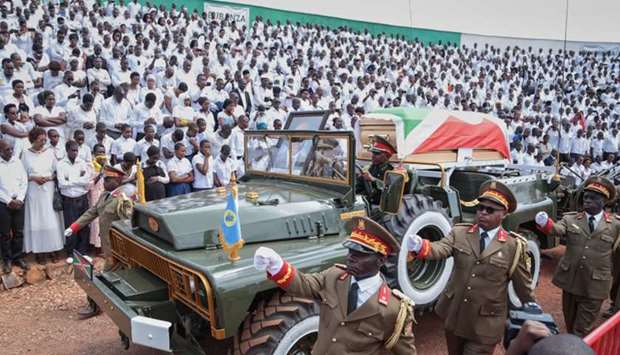 The coffin, covered with he Burundi national flag, of late Burundi President Pierre Nkurunziza, who died at the age of 55, is presented on a ceremonial vehicle during the national funeral at the Ingoma stadium in Gitega, Burundi
