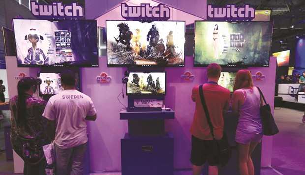 Visitors stream online computer games on the Twitch Interactive stand at Gamescom video games trade fair in Cologne, Germany. Tencent Holdings is rolling out a live-streaming service similar to Amazon.com Incu2019s Twitch in the US, making a rare foray into American social media.