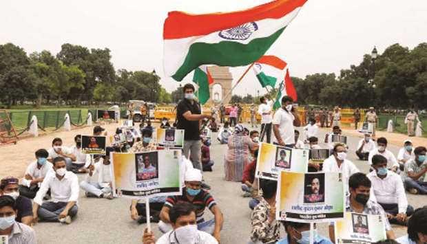 Supporters of Congress party hold placards while paying tribute to Indian soldiers killed in a border clash with Chinese troops in Ladakh region, at India Gate, in New Delhi yesterday.