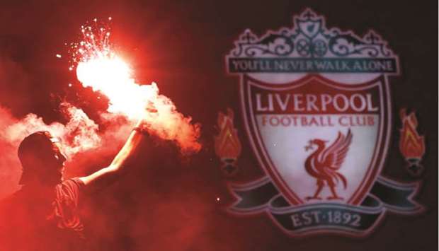 Liverpool fans celebrate winning the Premier League  after Chelsea won their match against Manchester City on Thursday.