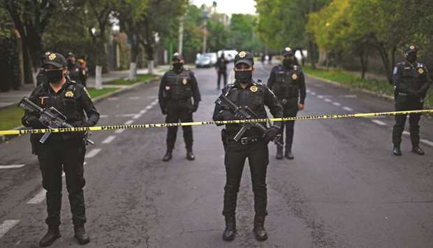 Police officers secure the area after Mexico Cityu2019s public security secretary Omar Garcia Harfuch was wounded in an attack in Mexico City yesterday.