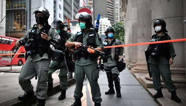 Riot police officers stand guard in the Central district of Hong Kong