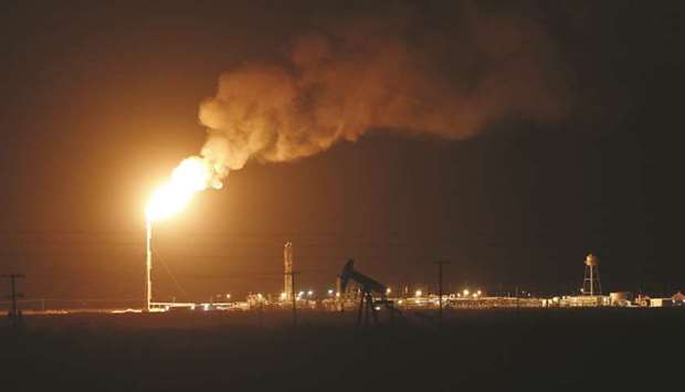 The silhouette of an electric oil pump jack is seen near a flare at night in the oil fields surrounding Midland, Texas. (file). Since US futures turned negative back in April, investors and companies have been drifting away from West Texas Intermediate, the flagship US grade.