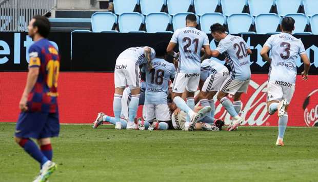 Celta Vigou2019s Iago Aspas (also inset) celebrates scoring their second goal with teammates during the La Liga match against Barcelona at Balaidos in Vigo, Spain, yesterday. (Reuters)