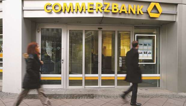 Pedestrians pass the entrance to a Commerzbank bank branch in Frankfurt. Commerzbank said in February that itu2019s working on deeper cost cuts after CEO Martin Zielkeu2019s previous plan, presented less than a year ago, was widely rejected by investors as disappointing.