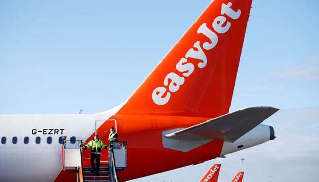 Staff close the doors of a plane ready for departure, as EasyJet restarts its operations at Gatwick Airport, in Gatwick, Britain June 15. REUTERS