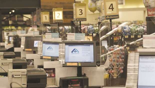 Signage is seen on point-of-sale terminals in the check-out area at Albertsons Cos grocery store in San Diego, California. Albertsons emerged from 14 years of private ownership by Cerberus Capital Management with a whimper on Friday, as its shares sagged after a shrunken initial public offering.