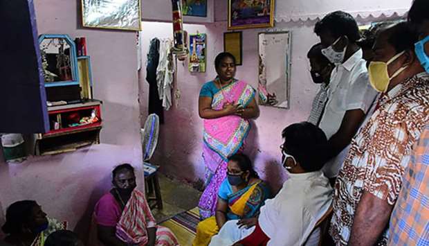 A priest consoles family members of Jayaraj and son Bennicks Immanuel, allegedly tortured at the hands of police in Sathankulam, Thoothukudi district of Tamil Nadu, yesterday.