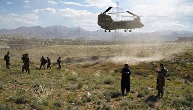 A US military Chinook helicopter lands on a field outside the governor's palace during a visit by the commander of US and NATO forces in Afghanistan, General Scott Miller, and Asadullah Khalid, acting minister of defense of Afghanistan, in Maidan Shar, capital of Wardak province. File picture: June 6, 2019