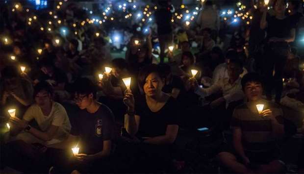 (file photo) People holding candles during a vigil in Hong Kong, to mark the 30th anniversary of the 1989 Tiananmen crackdown in Beijing