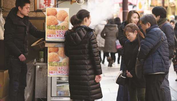 Customers look at sweets at a stall in Yokohama. Japanu2019s retail sales fell 12.3% in May from a year earlier, pulled down by a slump in spending on big ticket items such as cars as well as clothing and general merchandise, trade ministry data showed yesterday.