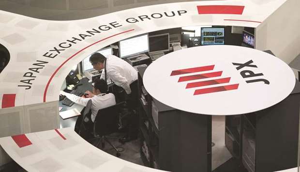 Employees work at the Tokyo Stock Exchange. The Nikkei 225 closed down 2.3% to 21,995.04 points yesterday.