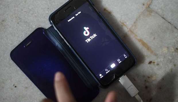 A person using the video-sharing app TikTok on a smartphone