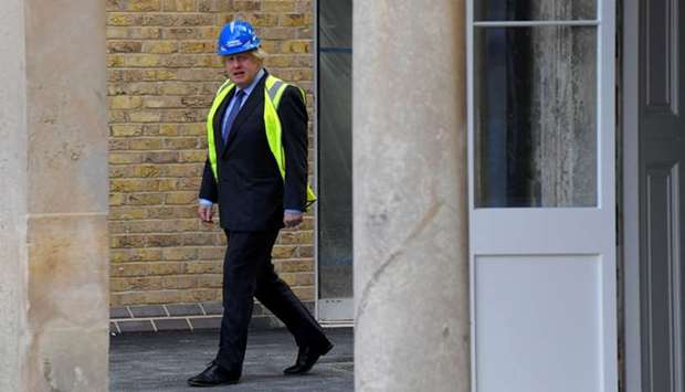 Prime Minister Boris Johnson visits the construction site of Ealing Fields High School, in west London yesterday.
