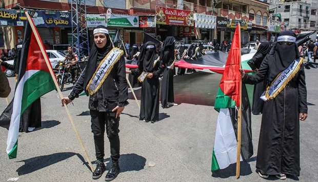 Palestinians rally against Israelu2019s West Bank annexation plans, in Rafah in the southern Gaza Strip, yesterday.