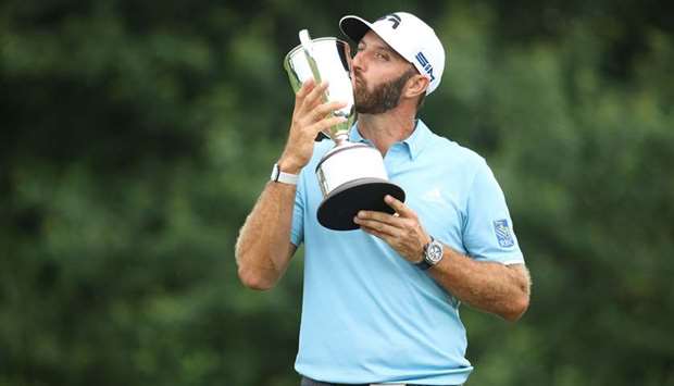 Dustin Johnson of the United States poses with the trophy after winning the Travelers Championship at TPC River Highlands in Cromwell on Sunday. (AFP)