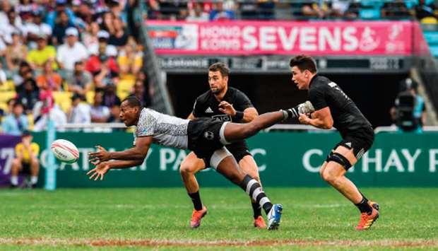 In this file photo taken on April 6, 2019, Paula Dranisinukula (left) of Fiji off loads the ball as Sam Dickson (right) of New Zealand tackles on the second day of the Hong Kong Sevens. (AFP)