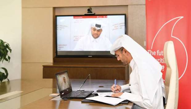 Khames al-Naimi and Mohamed al-Kubaisi signing the agreement in a virtual ceremony.