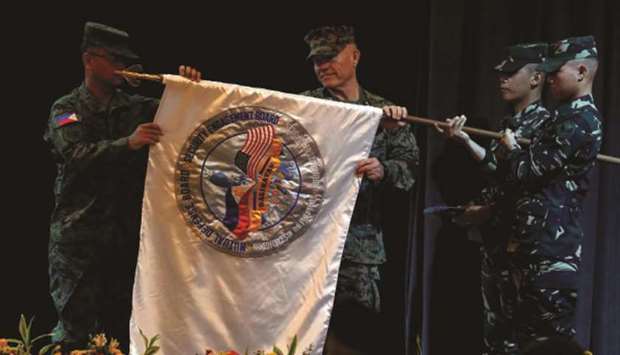 File photo taken on May 8, 2017 show US Marines officer Lt General Lawrence Nicholson (centre) and his counterpart from the Armed Forces of the Philippines Lt General Oscar Lactao (left) unfurl the u201cBalikatanu201d flag, during the opening ceremony of Philippines and US military joint exercises called Balikatan (Shoulder to Shoulder) at Camp Aguinaldo in Quezon city, Metro Manila.