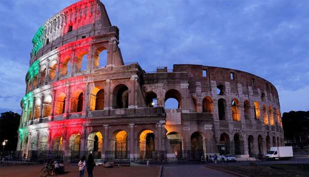 Rome's ancient Colosseum is lit with colours of the Italian flag to show unity, solidarity and to honour victims of the coronavirus disease (COVID-19) from all over the world, in Rome, Italy