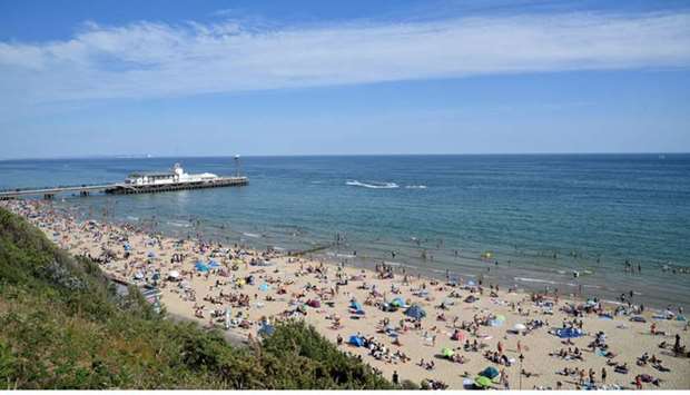 People flock to the beach in Bournemouth yesterday as they enjoy the hot weather, following the outbreak of the coronavirus.