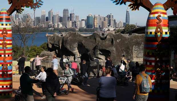Visitors walk between enclosures at Taronga Zoo Sydney as it re-opens to the public amidst the easing of the coronavirus disease (COVID-19) restrictions following an extended closure in Sydney, Australia