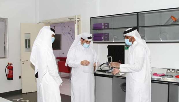 Officials during a physical examination of the face shield.