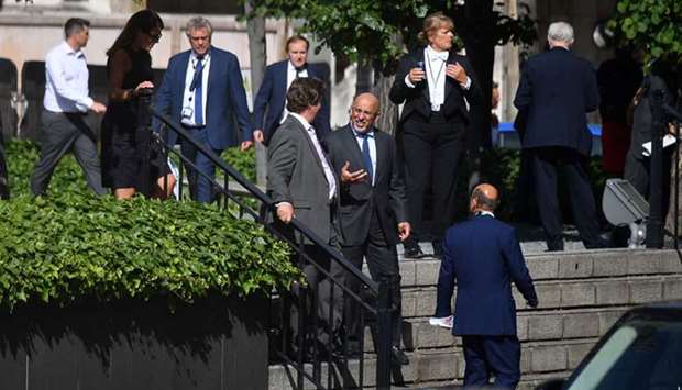 Conservative MP Nadhim Zahawi (centre) talks with other MPs as they are seen queuing in a courtyard on the parliamentary estate to vote on the motion of u2018Proceedings during the pandemicu2019, in the socially-distanced House of Commons in London yesterday.