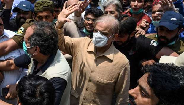 Opposition leader Shahbaz Sharif (centre) gestures as he arrives at the High Court in Lahore yesterday.