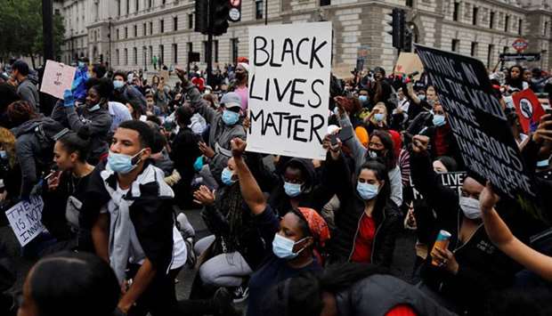 Protesters march on Parliament square during anti-racism demonstration in London yesterday after George Floyd, an unarmed black man died after a police officer knelt on his neck during an arrest in Minneapolis, US.