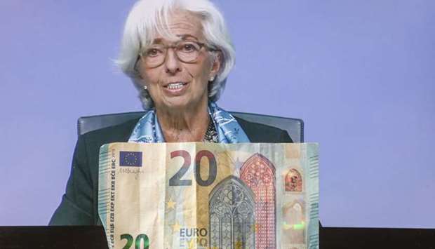 ECB president Christine Lagarde is displayed on a laptop computer during a live stream video of the central banku2019s virtual news conference in Frankfurt yesterday. Lagarde scotched speculation that the bank could follow the US Federal Reserve in buying sub-investment grade bonds, saying that option was not even discussed by policymakers.