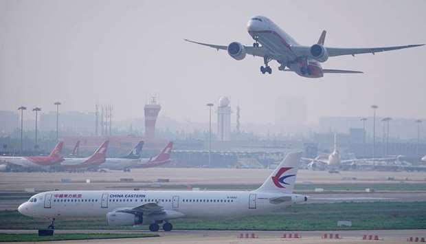 A China Eastern Airlines aircraft and Shanghai Airlines aircraft are seen in Hongqiao International Airport in Shanghai yesterday. China will ease its ban on foreign airlines starting June 8, changing course a day after the Trump administration demanded the country reopen to US airlines or face curbs on its own carriers flying passengers to America.