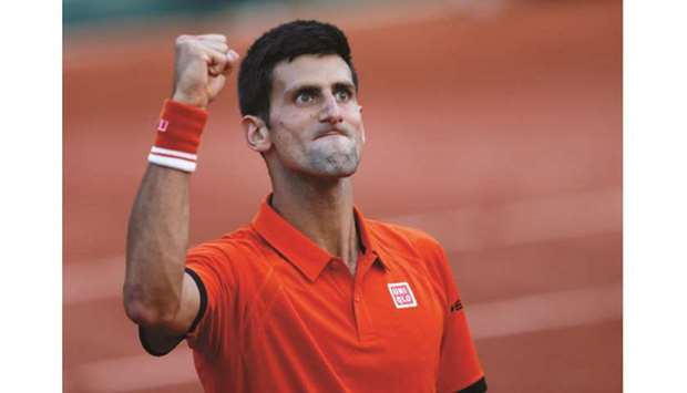 Novak Djokovic celebrates after his 6-3, 6-3, 5-7, 5-7, 6-1 victory over Andy Murray in the French Open semi-final in Paris on June 5, 2015. (Reuters)