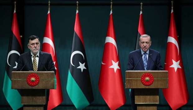Turkish President Recep Tayyip Erdogan and Libyau2019s internationally recognised Prime Minister Fayez al-Sarraj hold a news conference at the Presidential Palace in Ankara, Turkey, yesterday.