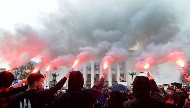 Demonstrators burn flares outside the Ukrainian parliament in Kyiv during a demonstration calling for the interior ministeru2019s resignation.