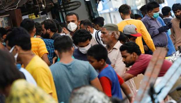 This picture taken earlier this week shows some men wearing face masks while the majority are not, outside an electronics market in Karachi.