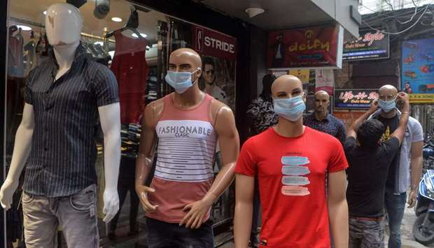Mannequins wearing face masks are installed outside a retail apparel store as a way to raise awareness regarding measures to take against the spread of the Covid-19 in Siliguri, West Bengal, yesterday.