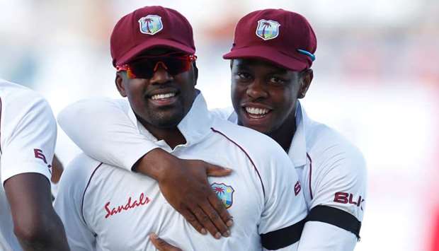 West Indiesu2019 Darren Bravo and Shimron Hetmyer (right) celebrate the end of an England innings during a Test match at the Sir Vivian Richards Stadium, North Sound, Antigua and Barbuda, on February 2, 2019. (Reuters)