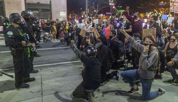 Protesters confront police as demonstrations continue over the killing of George Floyd despite the dangers of the widening coronavirus pandemic in Los Angeles, United States