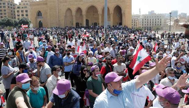 Lebanese protesters shout slogans during a demonstration in front of Mohamed al-Amin mosque in central Beirut, yesterday.