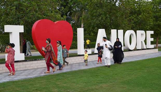 Members of a family enjoy a stroll at Lahoreu2019s Jilani park after it reopened with the easing of the lockdown imposed as a preventative measure against the spread of the coronavirus.