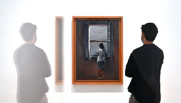 A man stands next to the painting Girl at the window by Spanish painter Salvador Dali at Madridu2019s Reina Sofia Museum.