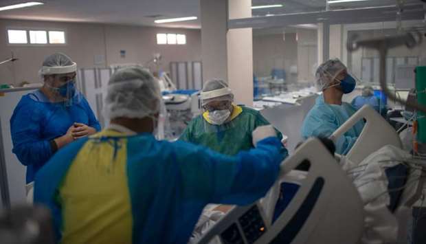 Health professionals take care of a patient at the Intensive Care Unit (ICU) ward where patients infected with the novel coronavirus, are being treated at the Doctor Ernesto Che Guevara Public Hospital in Marica city, state of Rio de Janeiro, Brazil